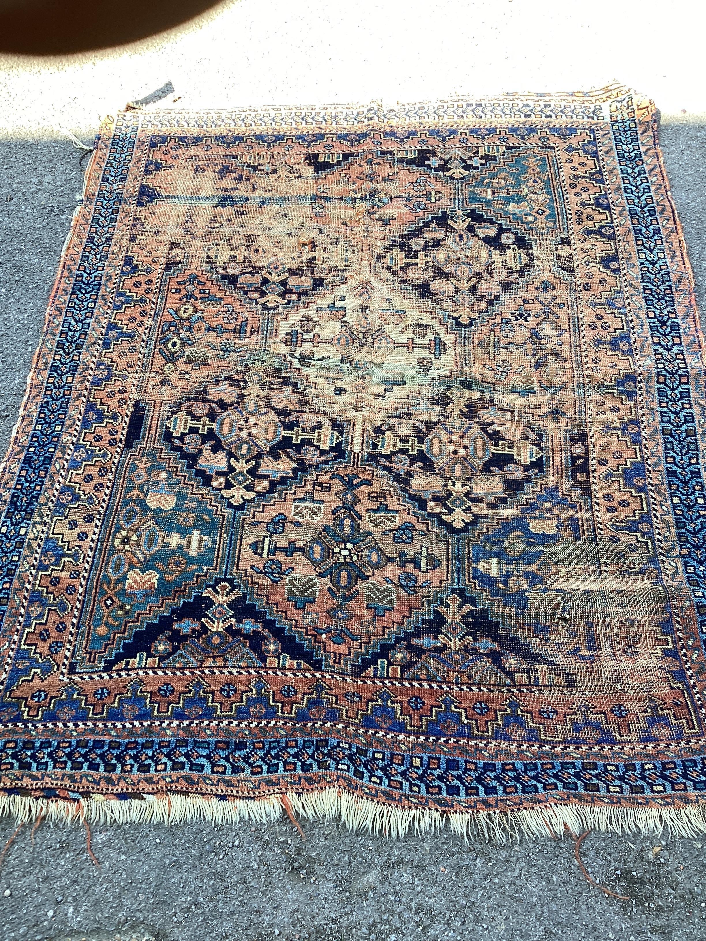 An antique Afshar blue ground rug 165cm x 133cm.